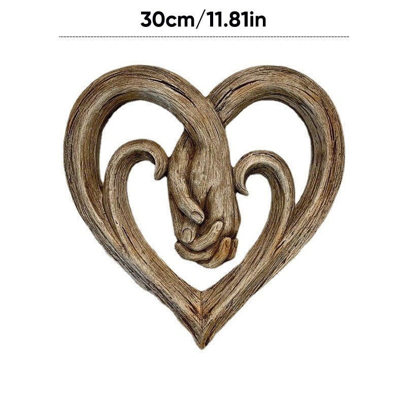 Decorazione da parete con cuore che si tiene per mano