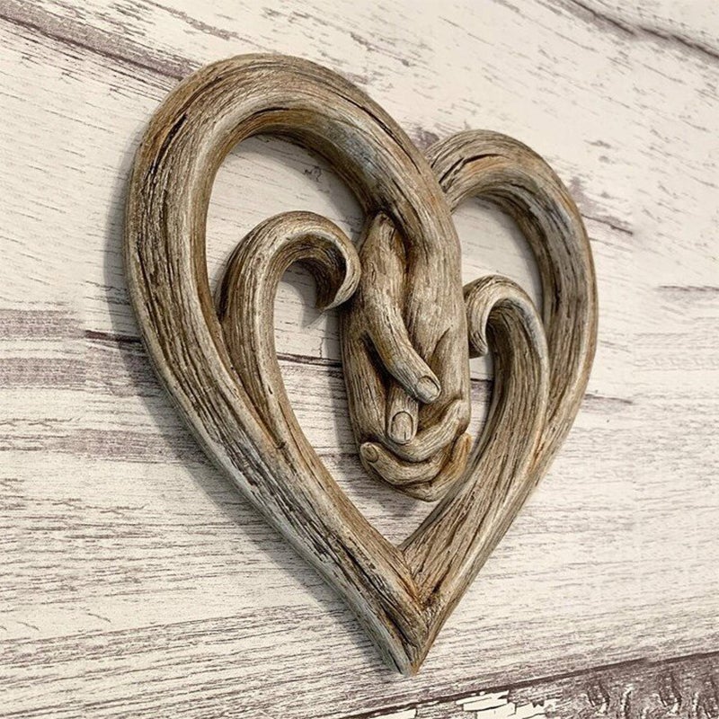Decorazione da parete con cuore che si tiene per mano