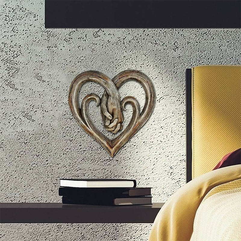 Decorazione da parete con cuore che si tiene per mano
